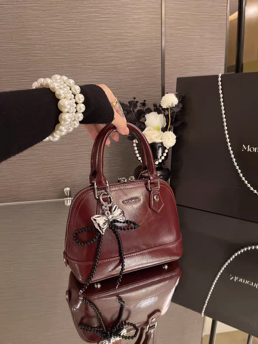 حقيبة يد نسائية صغيرة الحجم تصميم دوم لون عنابي - KSA