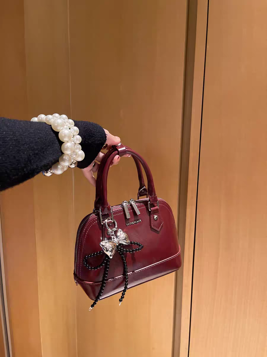 حقيبة يد نسائية صغيرة الحجم تصميم دوم لون عنابي - KSA