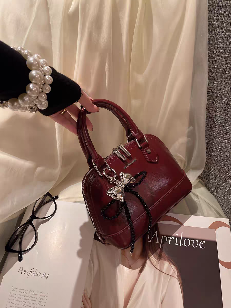 حقيبة يد نسائية صغيرة الحجم تصميم دوم لون عنابي - KSA